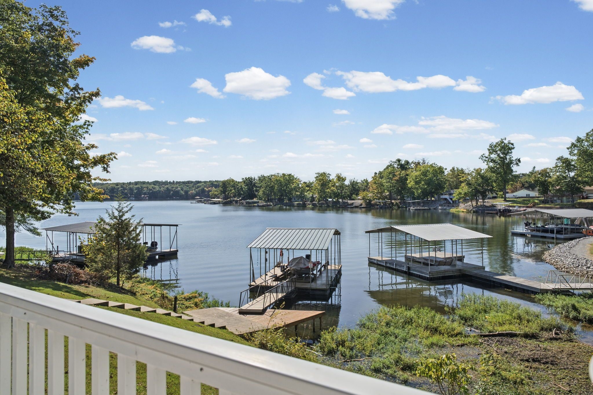 A lake with docks and a covered boat ramp.