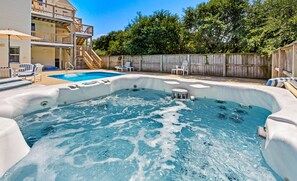 A backyard with a hot tub, a pool, and a wooden deck. - Family Affair Corolla retreat with private pool, hot tub, and easy beach access. (Corolla)