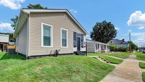 A single-story house with a front porch, a visible number '326', and a well-maintained lawn. - Sleeps 8 • Fenced Yard and Firepit • 8 Minutes to Louisville (Jeffersonville)