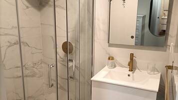 Shower, hair dryer, towels, toilet paper