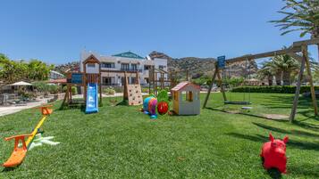 A playground with a slide, swings, and climbing structures.