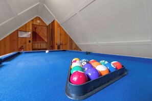A pool table with a blue felt surface and a rack of billiard balls. - The Gingerbread House | Sauna, HotTub, Lake Access (Twain Harte)