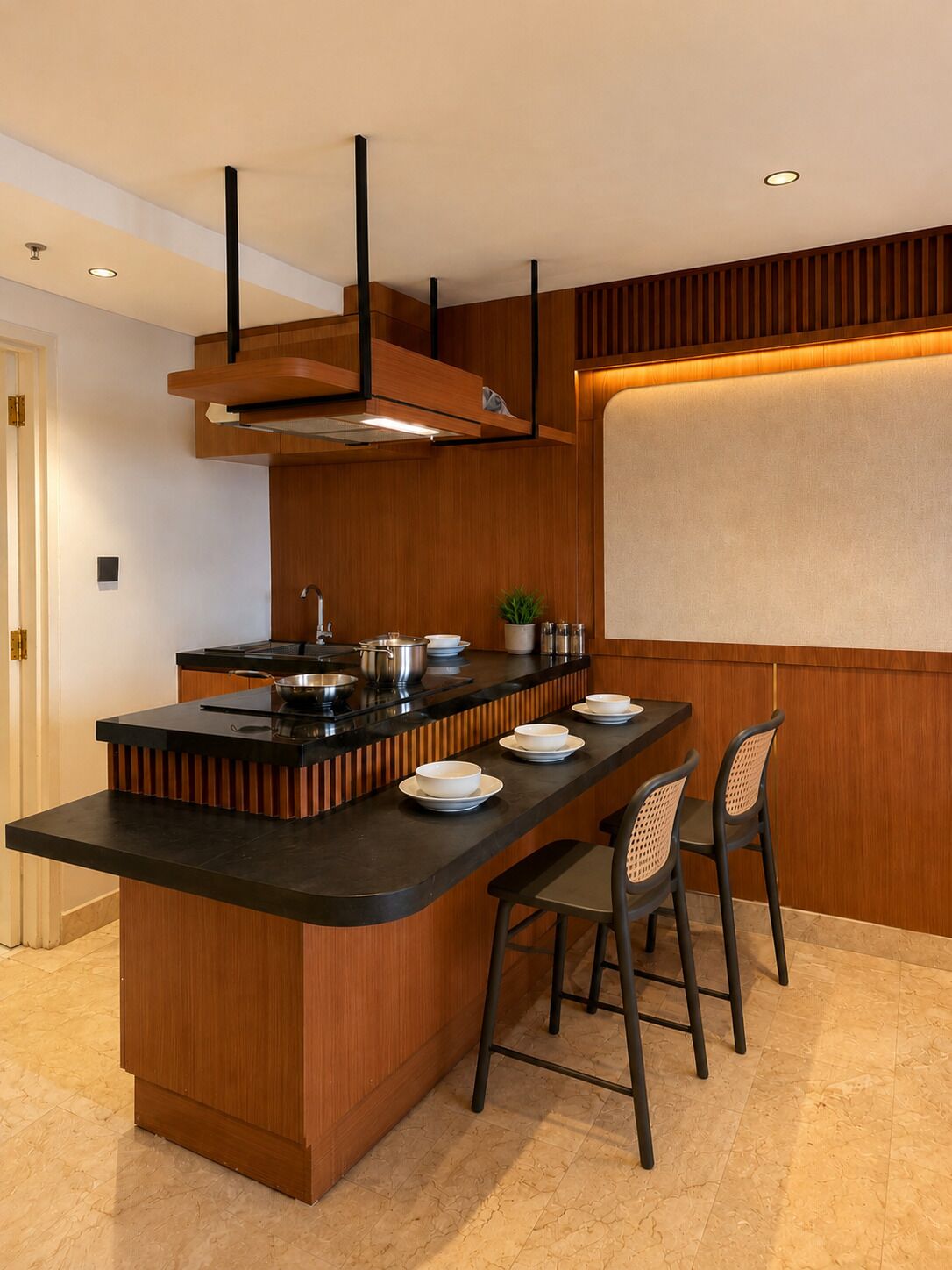 A modern kitchen with a central island, black countertops, wooden paneling, and a built-in stove.