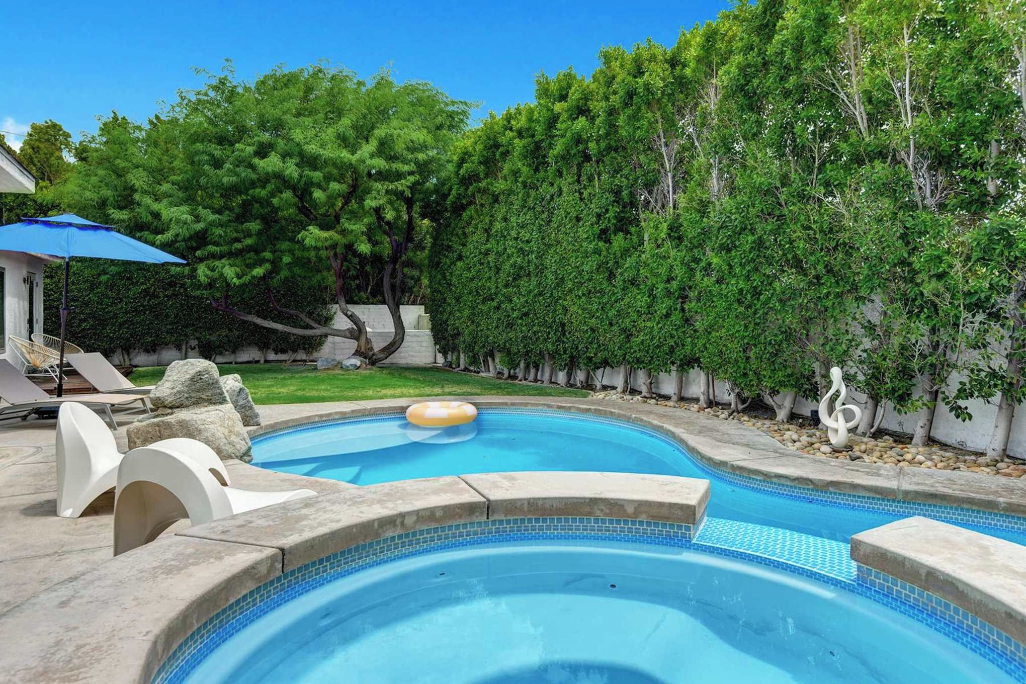 Dive into your private pool, soak in the bubbling hot tub, and unwind on the sun loungers surrounded by lush, mature trees and tranquil garden views.