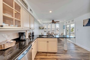A modern kitchen with a central island, built-in cabinets, and a dishwasher. - Rooftop Deck & Sunset Views, Avalon House (Avalon)