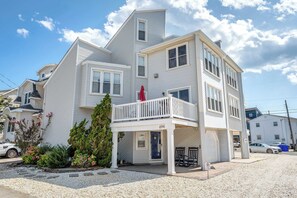 A multi-story residential building with a balcony, a garage, and a driveway. - Rooftop Deck & Sunset Views, Avalon House (Avalon)