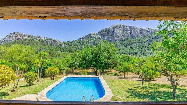A pool with a view of mountains and trees. - Can Pep – Country House in Pollensa with Pool (Pollenca)
