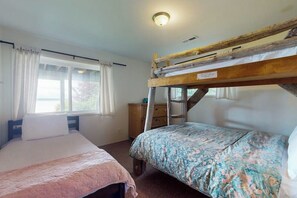 A room with bunk beds, a window with curtains, a dresser, and a light fixture. - Eastside Beachside Greenbank Getaway (Greenbank)