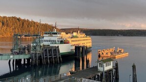 A ferry docked at a pier with a small building nearby. - Renovated 3 Bedroom Eastsound Home with Hot Tub Fire Pit and Stunning Sound Views (Eastsound)