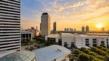 A cityscape with modern buildings, a clear sky, and a sunset.