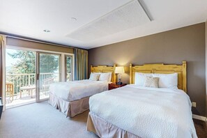 Ett hotellrum med två sängar, en balkong och utsikt över omgivningarna.