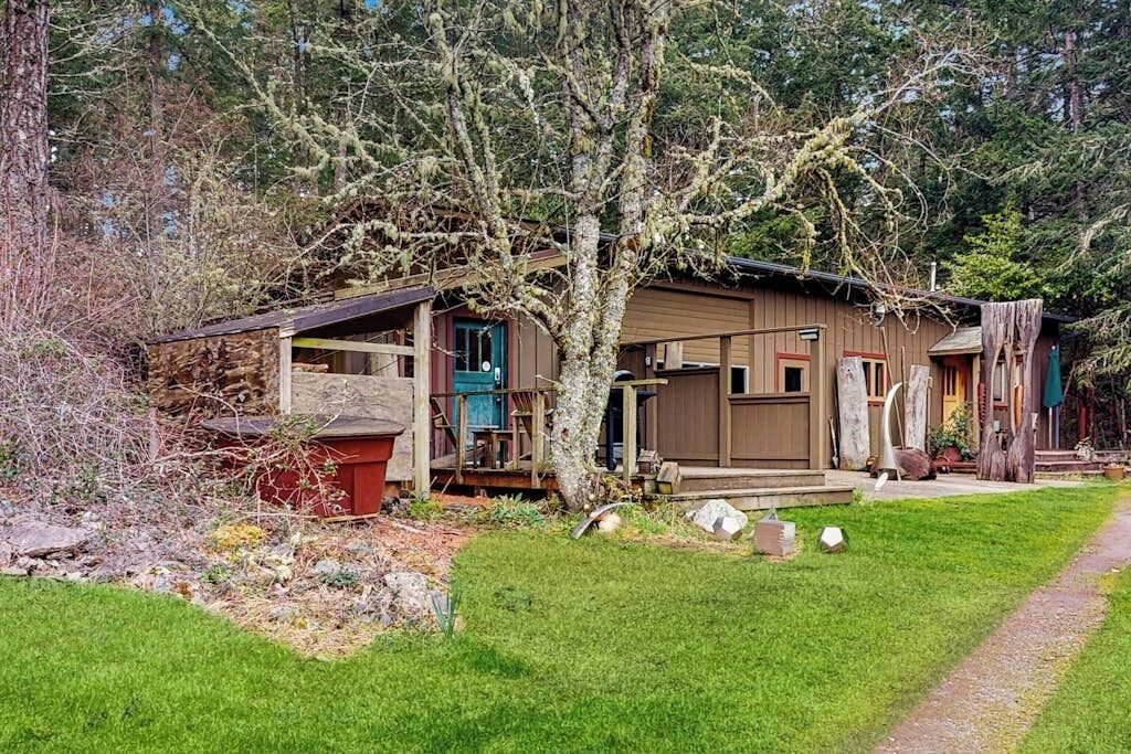 A rustic cabin with a wooden exterior, a porch, and a small deck.