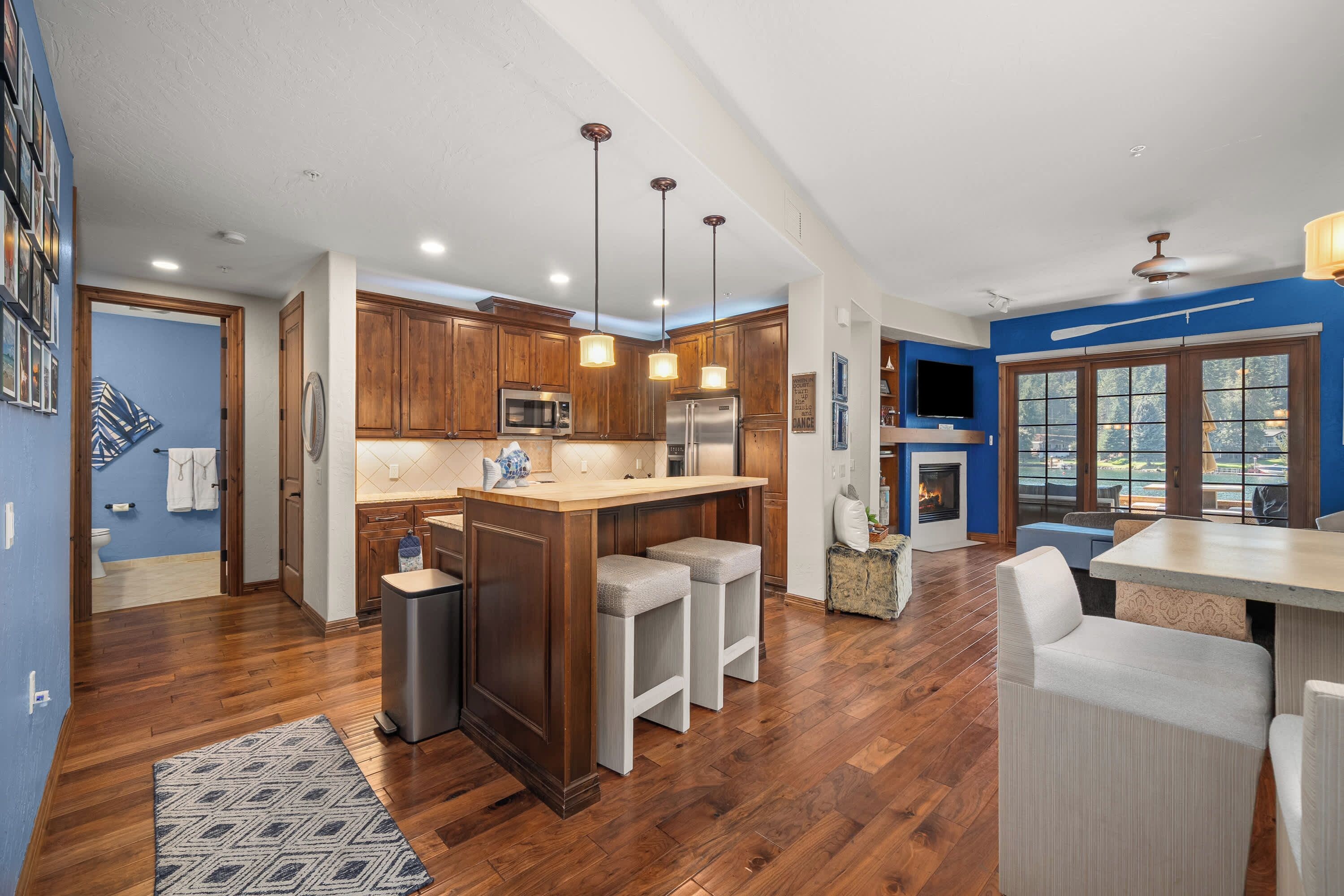 A modern kitchen with wooden cabinets, stainless steel appliances, and a central island.