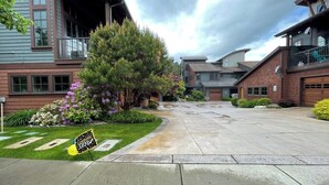 A residential street with houses, a grassy area, and a sign indicating a graduation event. - Vesper Bleu  2 Kings + EV Charger (Coeur d'Alene)