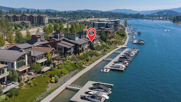 A waterfront property with a marina, modern buildings, and a view of the river.