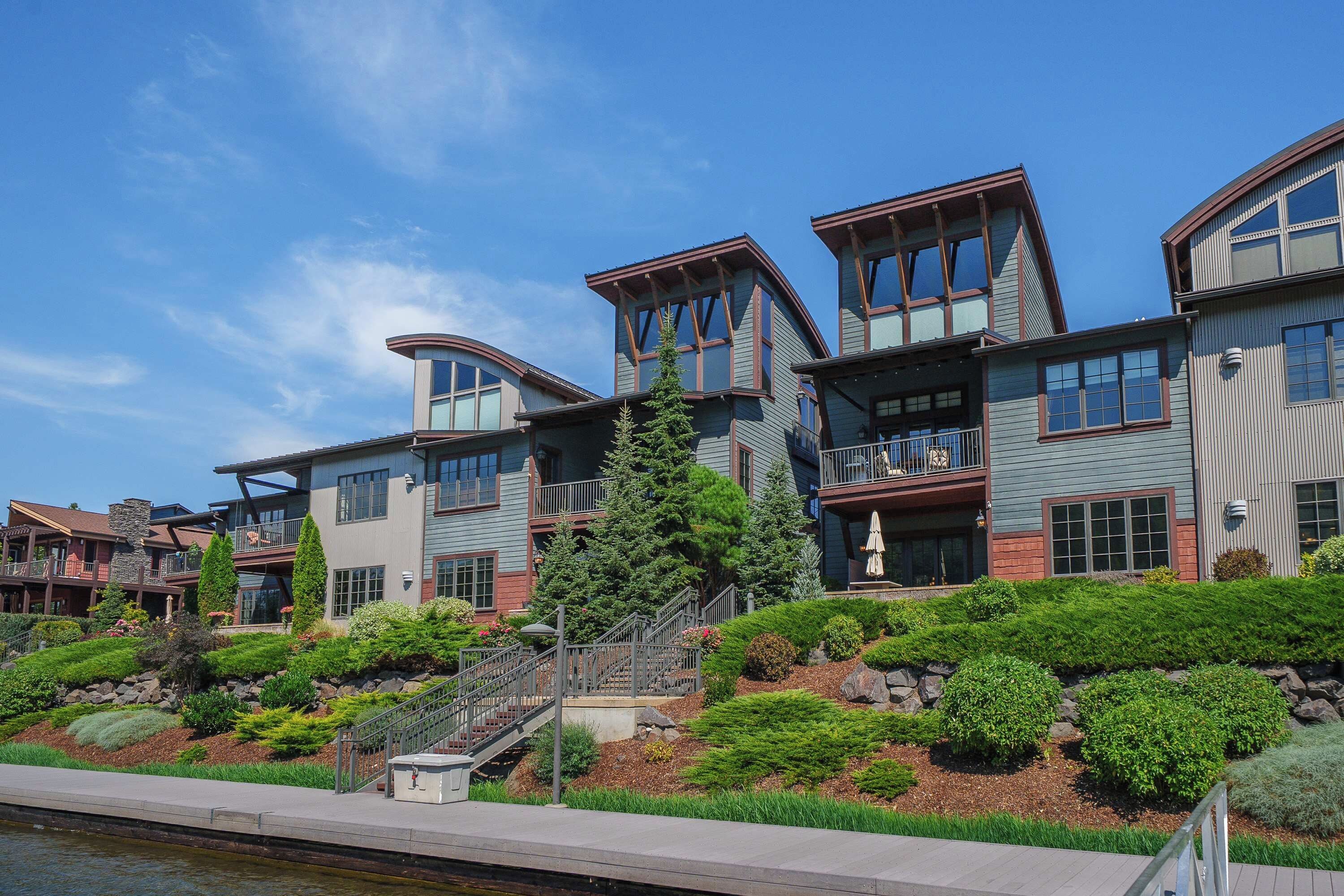 Beautiful waterfront residences with distinctive architecture and a walkway along the marina.