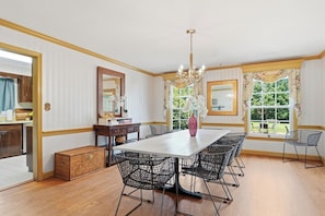 A dining area with a large table, chairs, a chandelier, and a view of the outdoors. -
The Bishop Retreat 5BR, Tennis Court & Yard (Alexandria)
