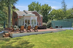 A brick house with a covered patio area featuring outdoor furniture and a pool. -
The Bishop Retreat 5BR, Tennis Court & Yard (Alexandria)