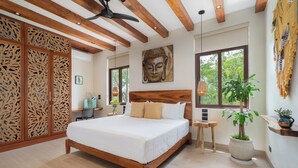 A bedroom with a wooden bed, a ceiling fan, a Buddha painting, and a large window. - "Rana Curiosa" @BlueDeerTulum - 4 Bed+4.5 Bath LUX Villa - Pool, Jacuzzi, Staff (Tulum)