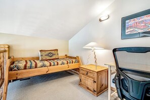 A bedroom with a single bed, a nightstand, a desk, and a chair. - Mountain View Home with Private Hot Tub & Patio - Close to Golf & Trails (Moab)