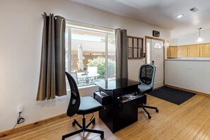 A room with a desk, chair, and a view of the outdoors. - Dog-Friendly Townhome with WiFi, Nice Views & Indoor Pool (Moab)