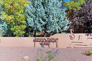 A sign for Solano Valley Villas with a clear view of surrounding trees. - Lovely Moab Townhouse with Shared Pool Near Arches National Park (Moab)
