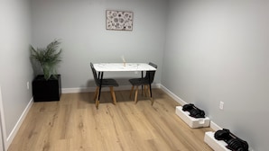 A dining area with a table, chairs, a potted plant, and a wall-mounted artwork. - Escape to a bright and spacious home tucked into a quiet, welcoming neighborhood (Edmonton)