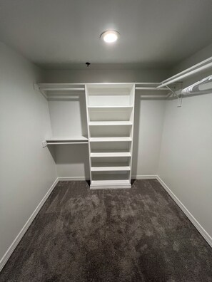 A walk-in closet with a built-in shelving unit and a ceiling light fixture. - Sun Devil at 5th & Mill - ASU, Mill Ave & Spring Training (Tempe)