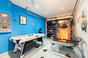 A room with a foosball table, a basketball hoop, and a Star Wars-themed wall. - Our Happy Place! FREE Pool Heat (Davenport)