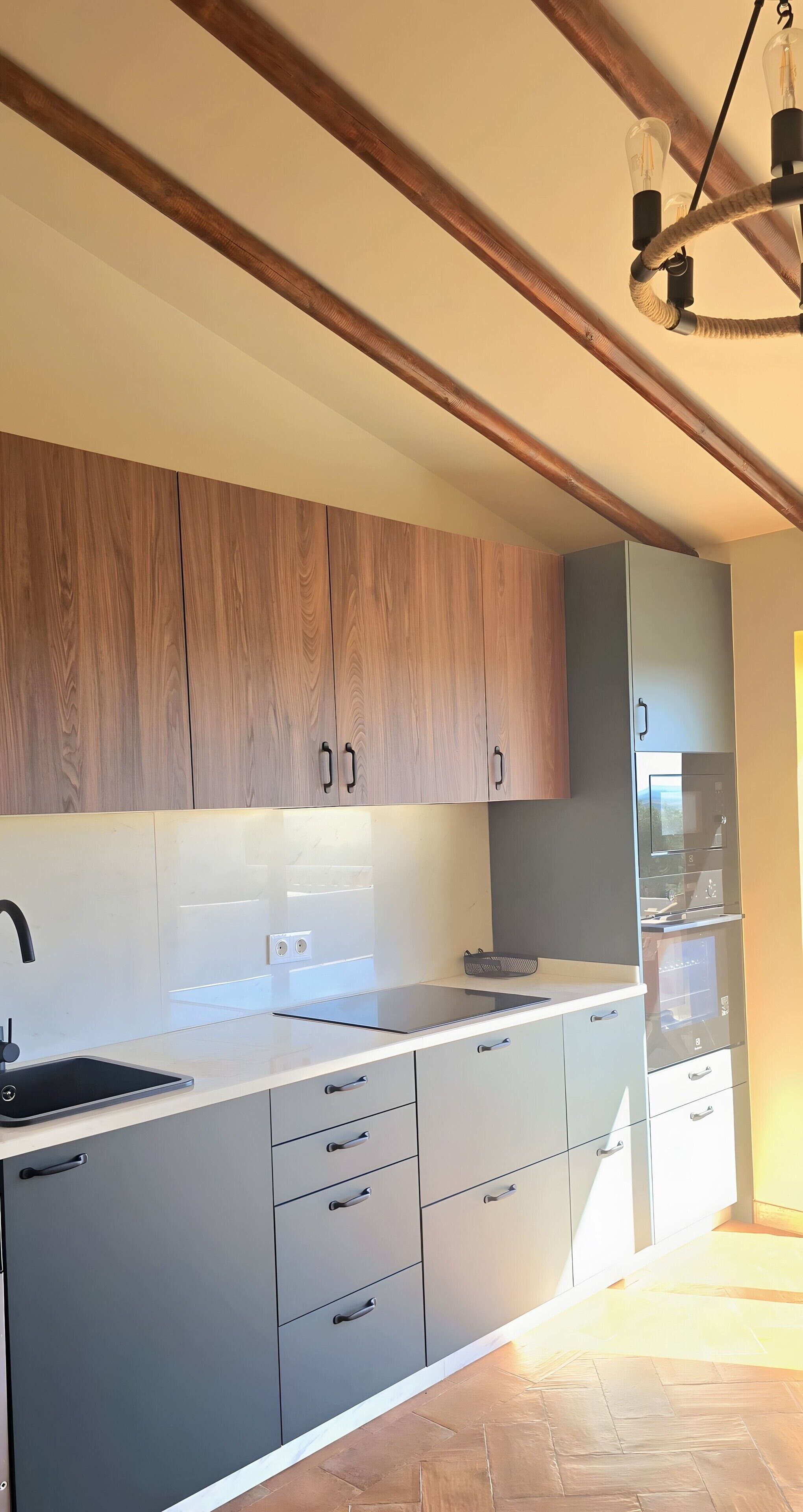 A modern kitchen with wooden cabinets, a white countertop, and a built-in refrigerator.