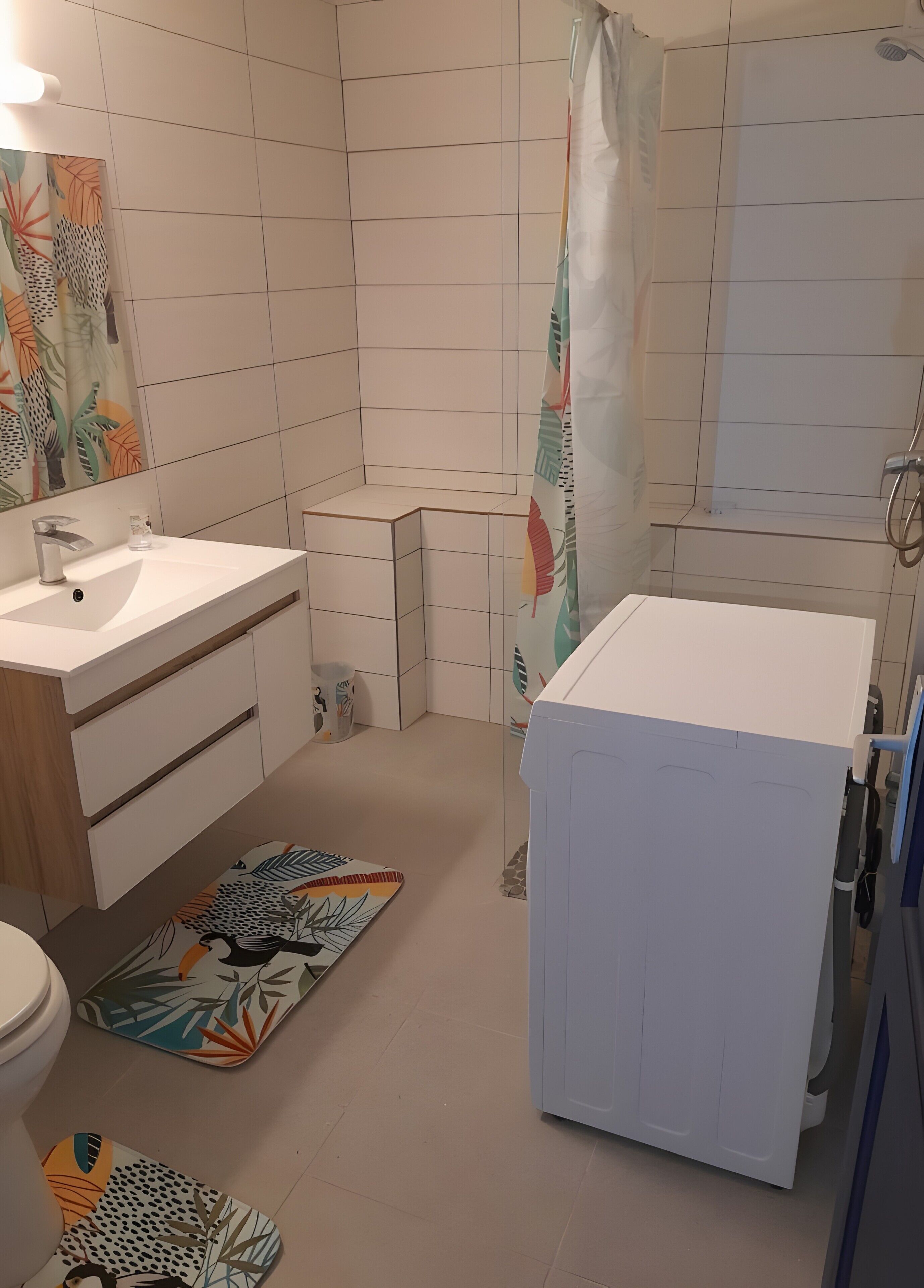 A bathroom with a white sink, a toilet, a shower area, and a bathtub.