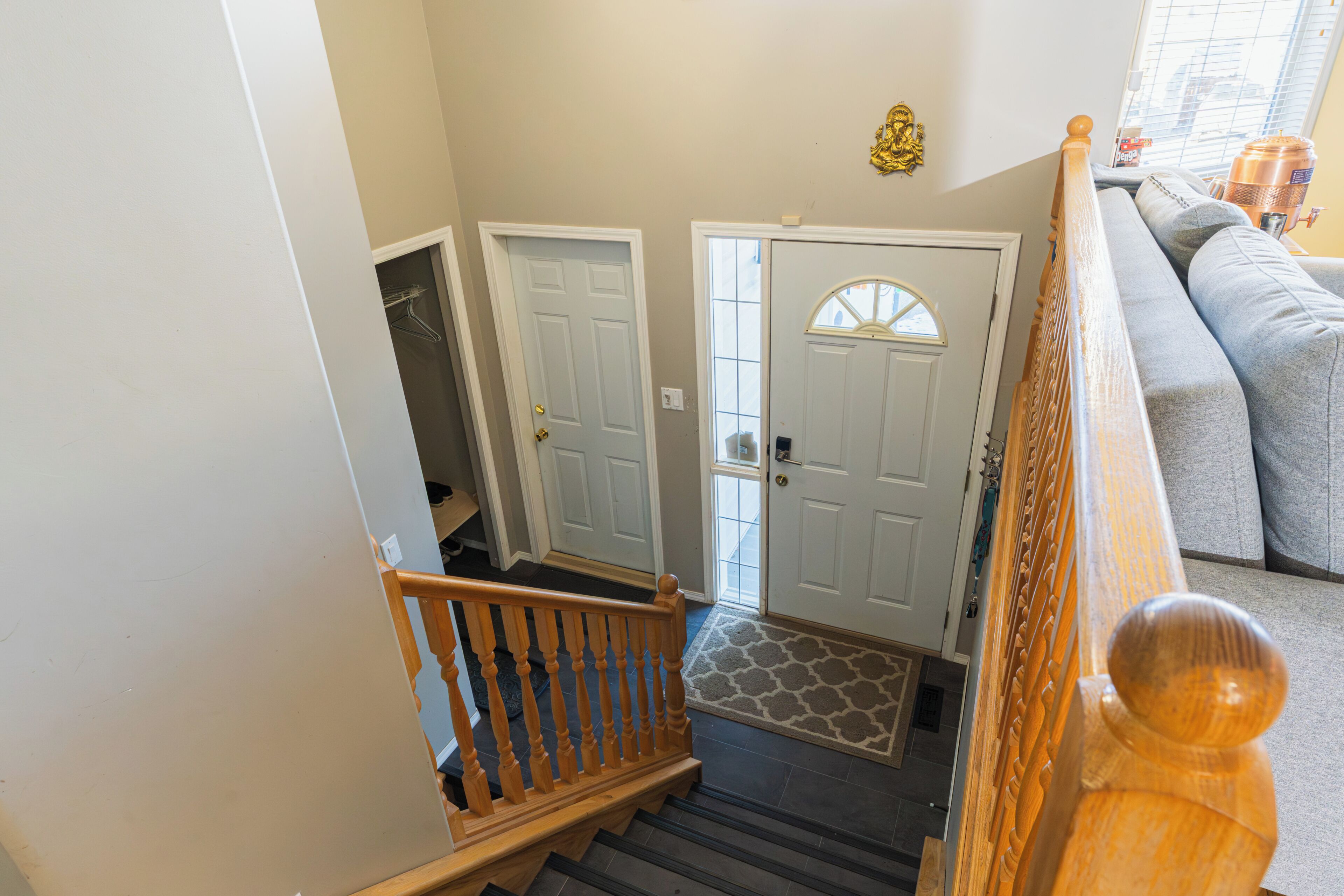 A staircase leading to a landing with a door and a window.