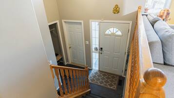 A staircase leading to a landing with a door and a window.