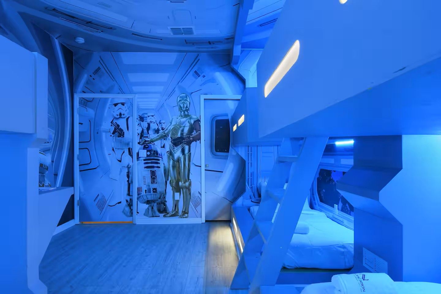 A room with a futuristic design, featuring geometric shapes and a central display of Star Wars characters.