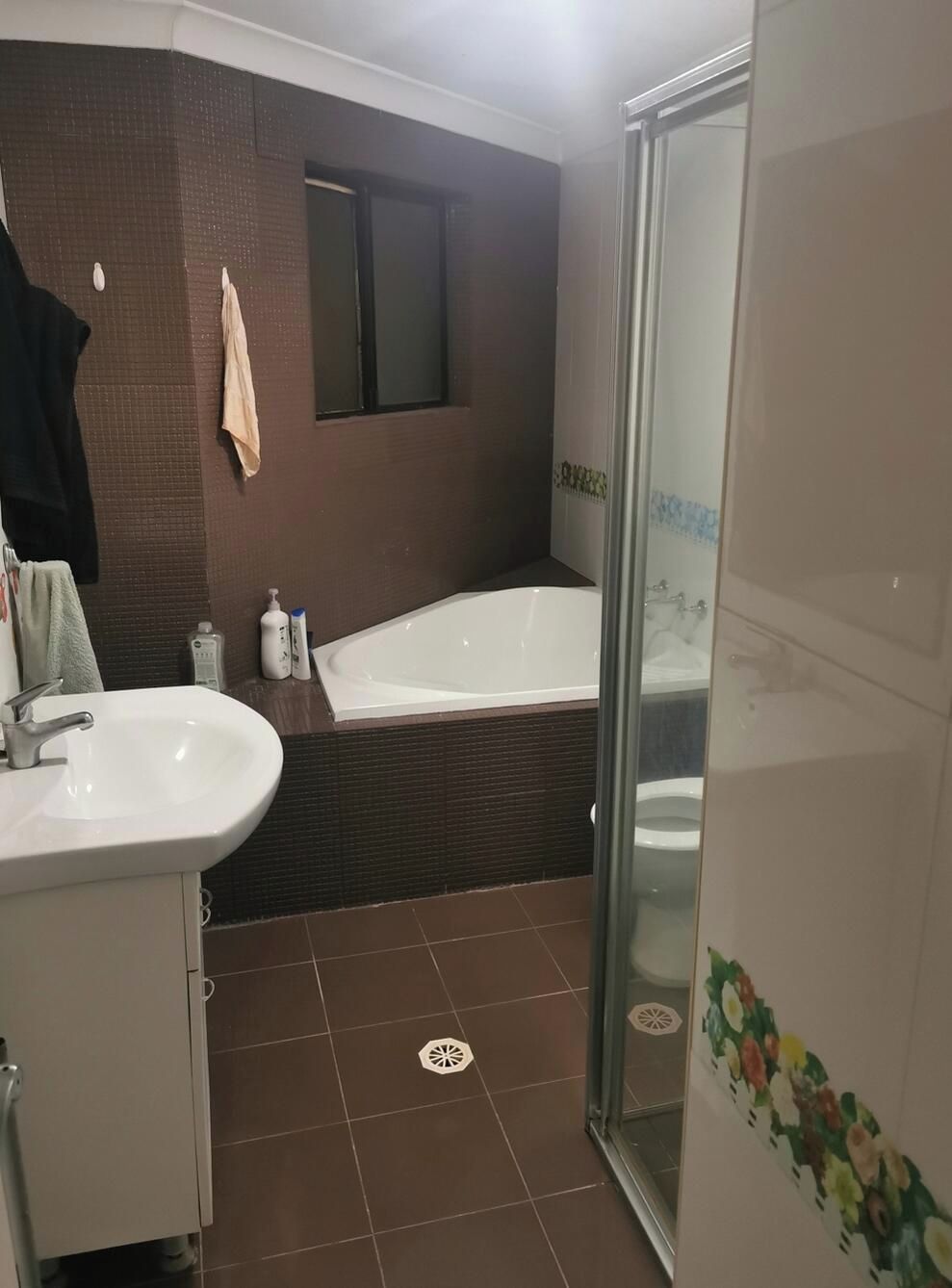 A bathroom with a bathtub, a shower, and a sink.