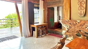 A room with a wooden table, a bench, and a decorative wooden piece.