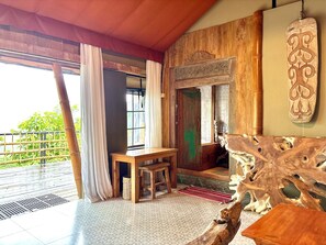 A room with a wooden table, a bench, and a decorative wooden piece.