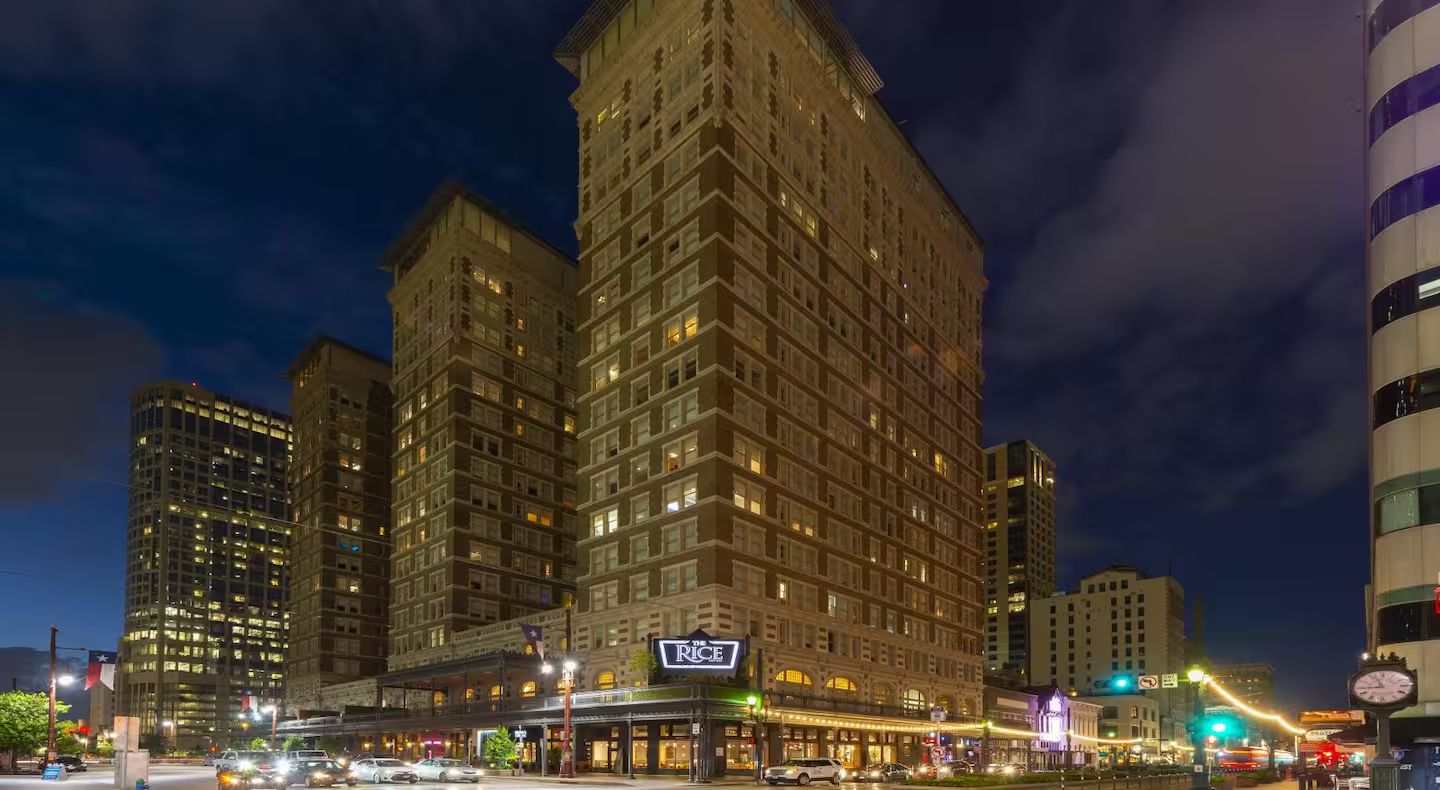 A multi-story hotel with a prominent sign for 'The Rice' at the ground level.