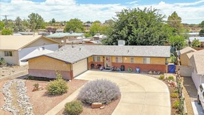 A residential building with a garage, a driveway, and a landscaped garden. - Shady Backyard Retreat  4BR Farmington  Sleeps 10 (Farmington)