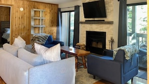A living room with a sofa, armchair, and a fireplace. - Perfect 1-bedroom condo, a 7 min walk to The Village (Mammoth Lakes)