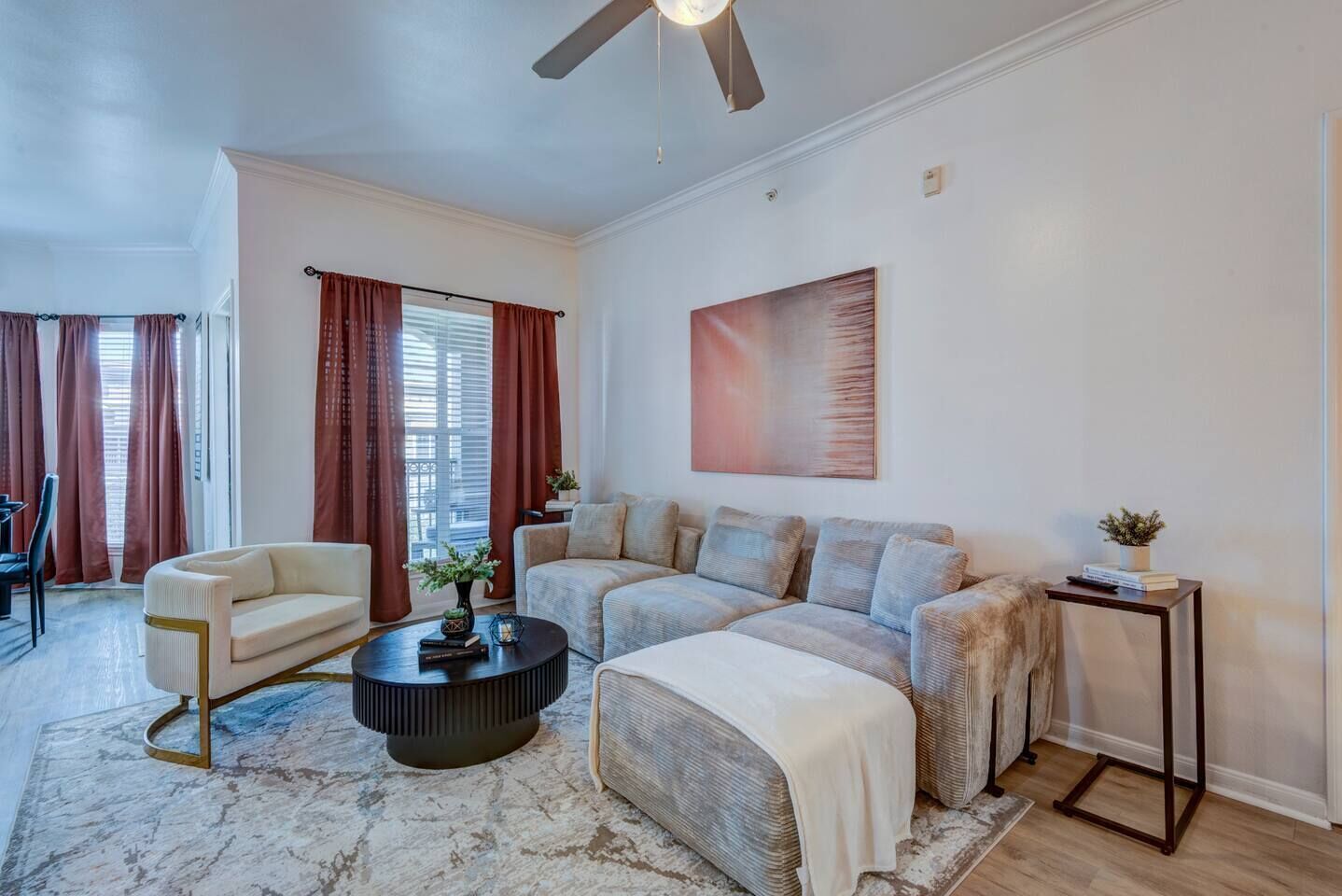 A living room with a sofa set, a coffee table, and a side table.