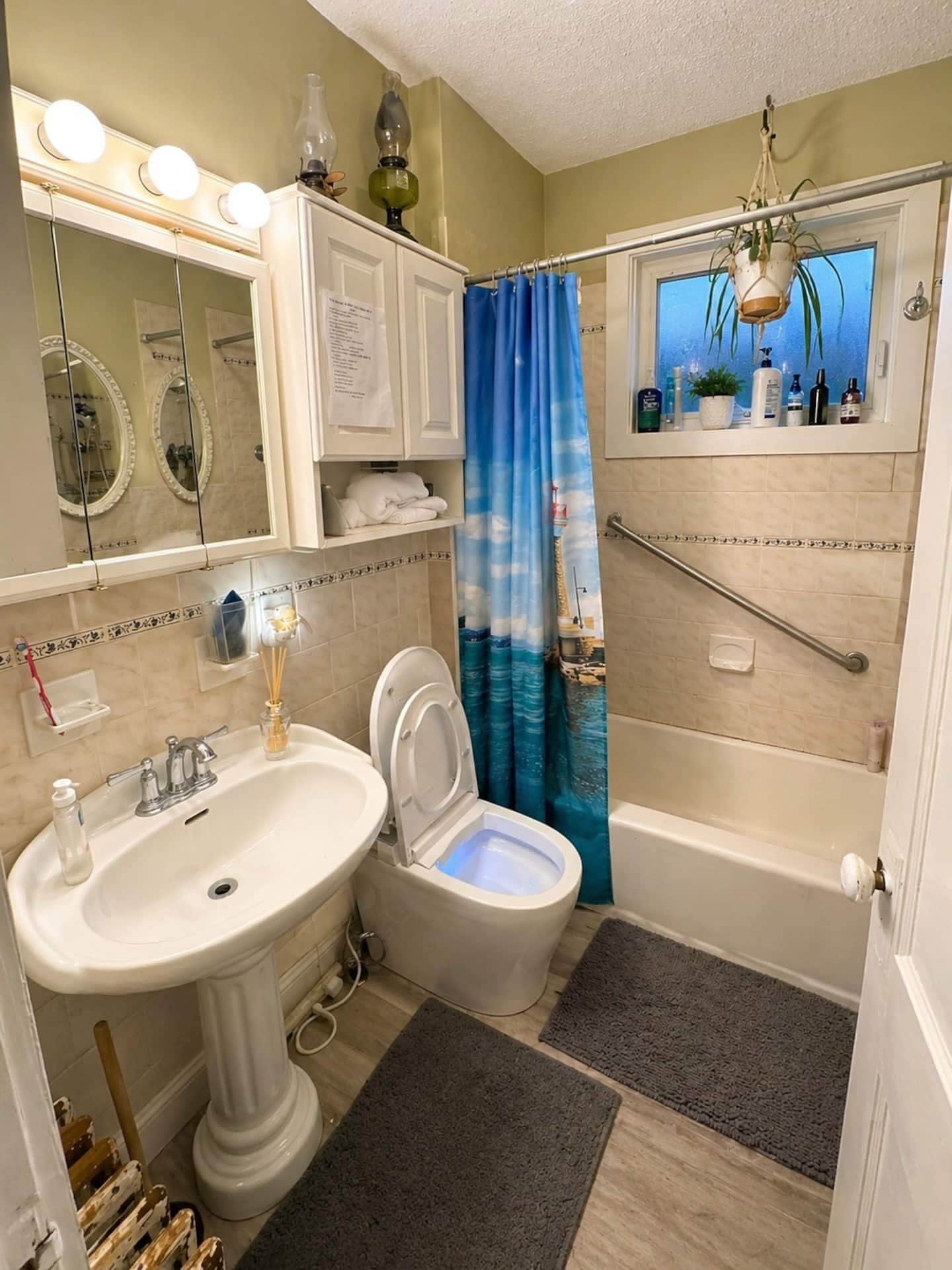 A bathroom with a toilet, sink, and bathtub.