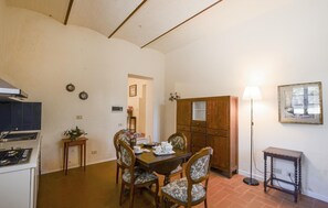 A dining area with a wooden table, chairs, and a cabinet. - Nice home in Poggibonsi with outdoor swimming pool (Poggibonsi)