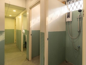 A bathroom with a shower, toilet, and a hand dryer. - Social Pod Khao San Hostel (Bangkok)
