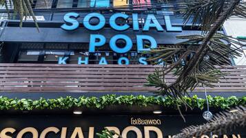 A building with a sign that reads 'SOCIAL POD KHOS' and another sign below it that says 'SOCIAL POD'.