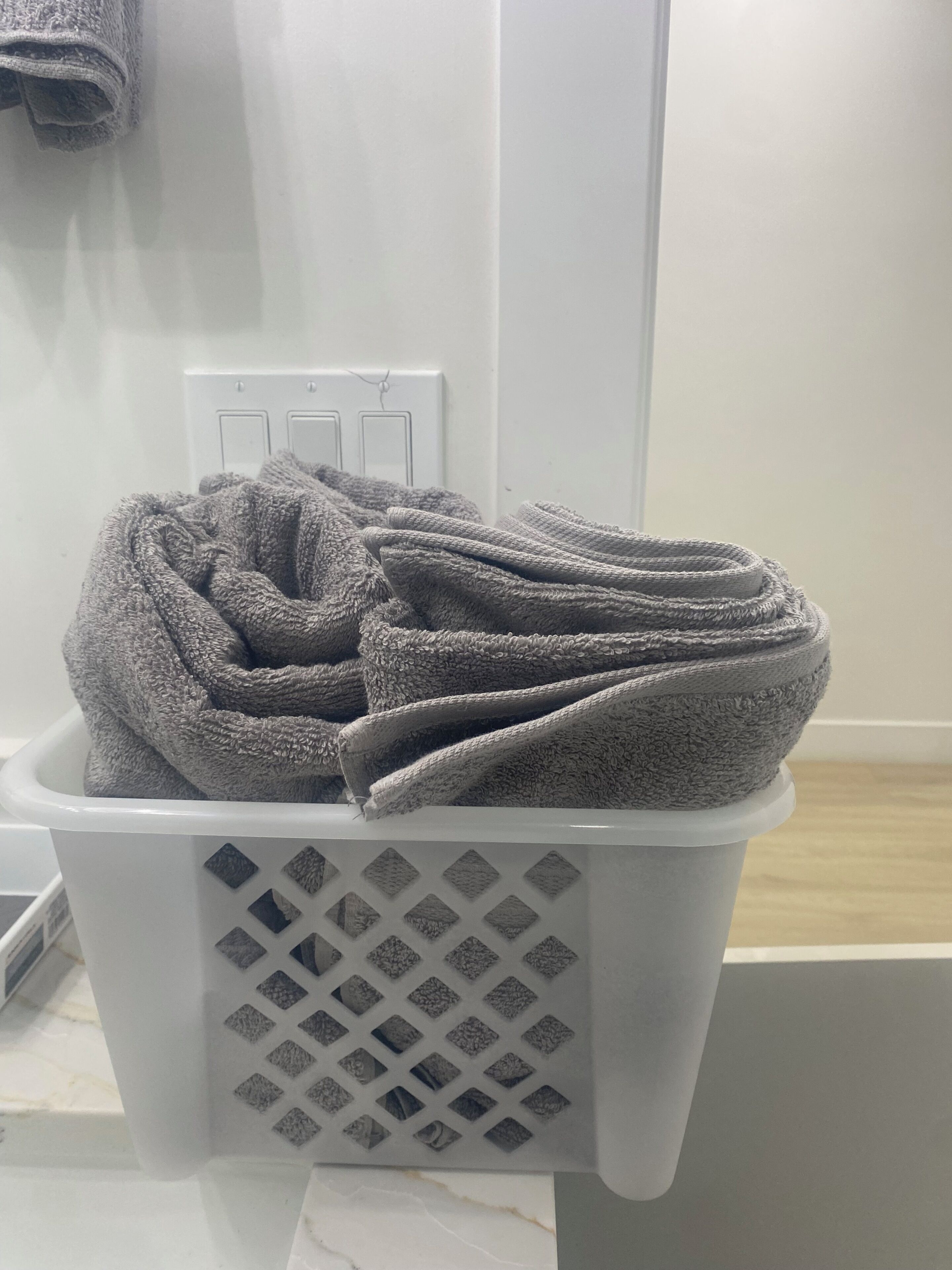 A laundry basket with folded towels.