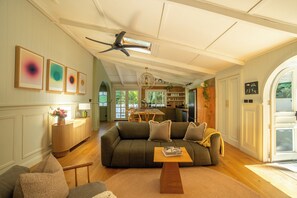 A spacious living room with a sofa, coffee table, and a ceiling fan. - VIMANA - Perfect summer getaway for large groups - Mullumbimby (Mullumbimby)