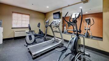 A gym with treadmills, an elliptical, and a stationary bike.