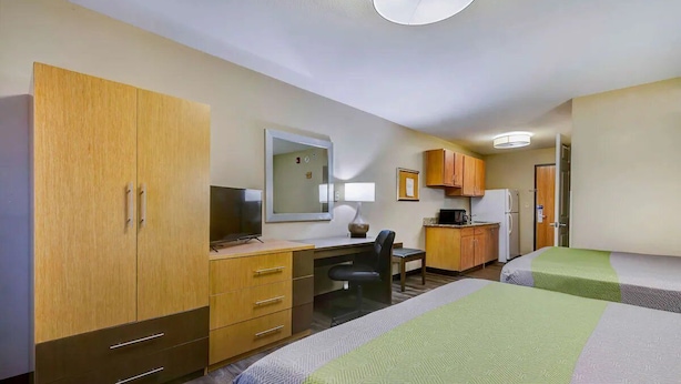A hotel room with two beds, a desk, a chair, a television, and a kitchenette. - 3 Pet-friendly Units w/ Kitchenette | Near Town Center Plaza - 6.7 miles (Johnson County)