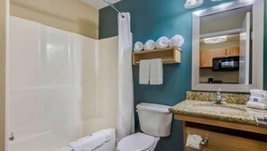 A bathroom with a bathtub, toilet, sink, and a mirror above the sink. - Relaxing Extended Stay | 4 Units Near Nerman Museum of Contemporary Art - 2.9 mi (Johnson County)